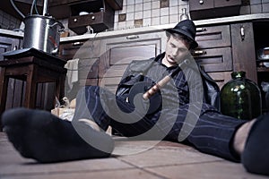 Young caucasian man with gun dead from bootleggers war during alcolol prohibition in USA in 1920-1930s. Concept scene, striped sui