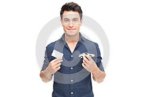 Young Caucasian man holding car insurance card