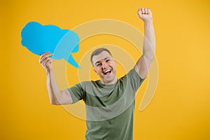 Young caucasian man isolated on yellow background holding a thinking speech bubble and doing OK sign