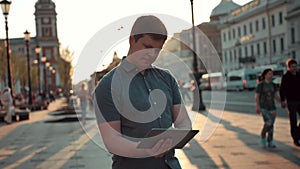 Young caucasian man navigate in city using tablet pc computer