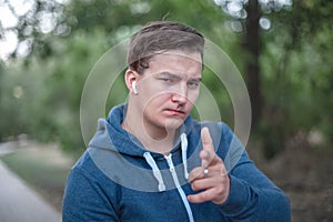 Young caucasian man points his finger to the viewer