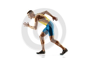 Young caucasian man running or jogging isolated on white studio background.