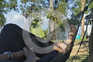 young caucasian man swinging in a hammock in a Monjai Chiangmai of a weekend morning