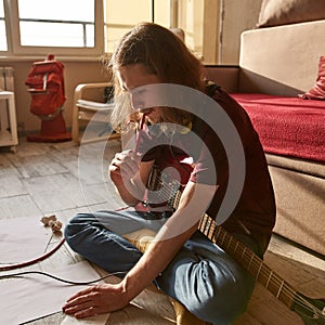 Young caucasian man think about text of new song