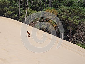 Young caucasian man walking in dune of Pilat at Arcachon Burdeos France photo