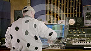 Young Caucasian man working at music recording studio