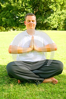 Young Caucasian Meditate In Park