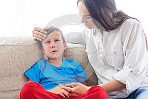 Young Caucasian mom soothing crying son