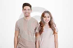 Young caucasian people 20s man and woman wearing beige t-shirts