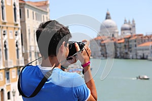 Young caucasian photographer in Venice in Italy