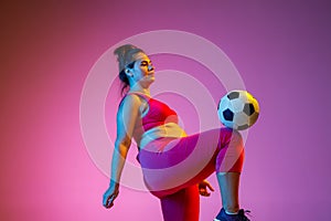 Young caucasian plus size female model`s training on gradient background