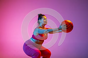 Young caucasian plus size female model`s training on gradient background