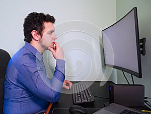 Young caucasian programer man thinking about a work problem