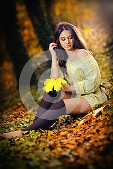 Young Caucasian sensual woman in a romantic autumn scenery. Fall lady .Fashion portrait of a beautiful young woman in forest