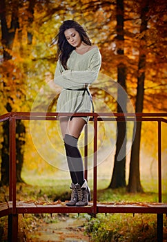 Young Caucasian sensual woman in a romantic autumn scenery. Fall lady .Fashion portrait of a beautiful young woman in forest