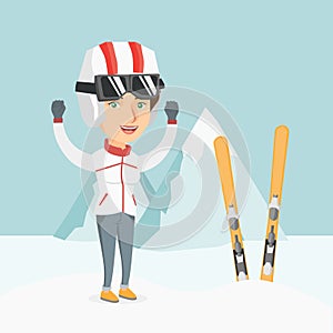 Young caucasian skier standing with raised hands.