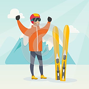 Young caucasian skier standing with raised hands.