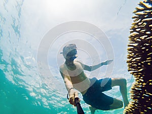 A young caucasian snorkeling man under water selfie Thailand