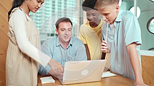 Young caucasian student asking teacher and pointing at laptop. Edification