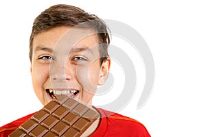 Young caucasian teenage boy with a bar of chocolate