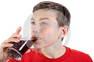 Young caucasian teenage boy drinking cola