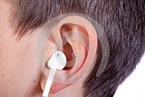 Young caucasian teenage boy`s ear and headphone