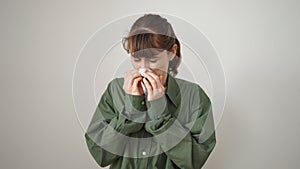 Young caucasian woman blowing her nose with a tissue over isolated white background