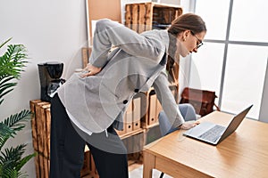 Young caucasian woman business worker suffering for backache at office