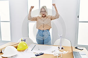 Young caucasian woman cheerful working at architect studio