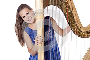 Young caucasian woman with concert harp in studio against white