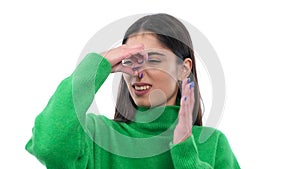 Young Caucasian Woman Covering Nose From A Stinky Odor On White Background