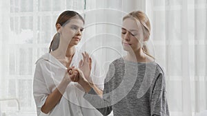 Young caucasian woman depressed while friends encourage in the bedroom at home.