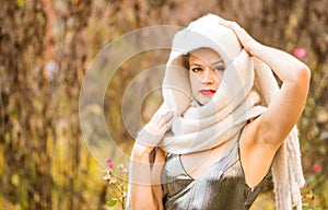 Young caucasian woman in a dress and a headscarf outdoors