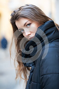 Young caucasian woman dressed in black clothes. Beautiful caucasian girl posing outdoor in Milan, Italy. Street fashion, winter