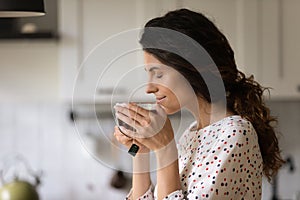 Young Caucasian woman drink back tea from cup