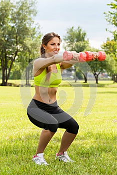 Young caucasian woman with dumbbells