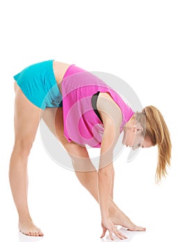 Young caucasian woman is exercising, bending down.