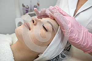 young caucasian woman getting facial spa massage at spa salon