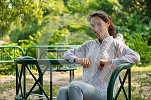 Young caucasian woman having fun relaxing in greenery natural park