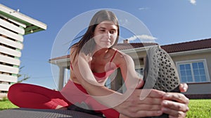 Young caucasian woman during her fitness routine in the morning outdoors