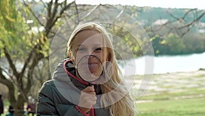 Young caucasian woman holding a magnifying glass.