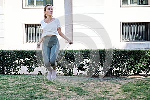 Young caucasian woman jumping rope