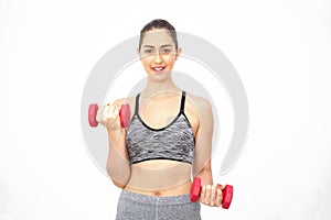 Young Caucasian woman lifting dumbbells over white background