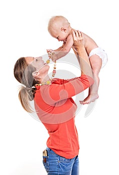 Young Caucasian woman lifting her baby son