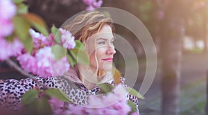 Young Caucasian woman looking away during sakura