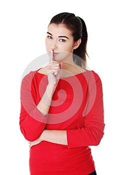 Young caucasian woman making silence sign