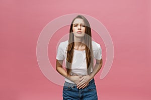 Young caucasian woman over isolated background with hand on stomach because indigestion, painful illness feeling unwell