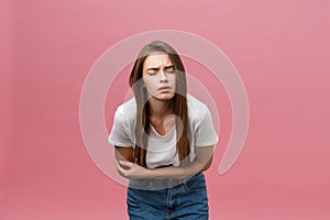 Young caucasian woman over isolated background with hand on stomach because indigestion, painful illness feeling unwell