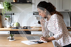 Young Caucasian woman pay bills on laptop online