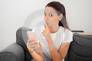 Young caucasian woman with phone. Censorship in internet.